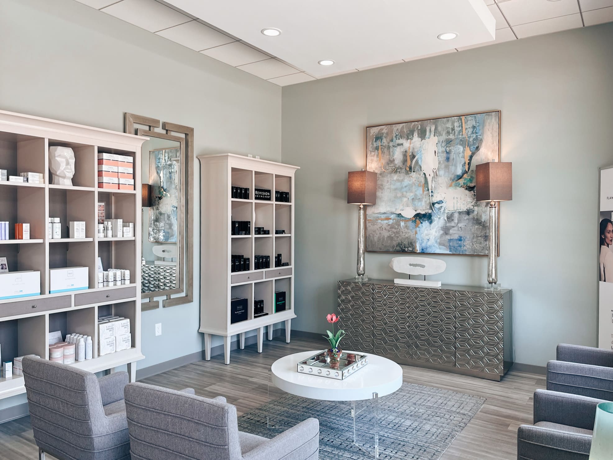 Commercial waiting area with custom shelving, modern seating and abstract artwork